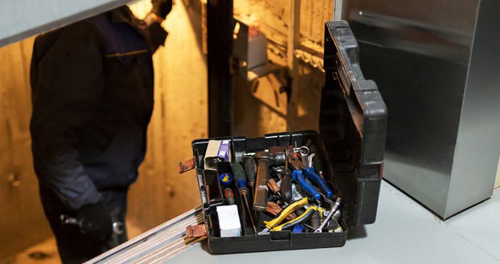 Elevator technician in elevator shaft