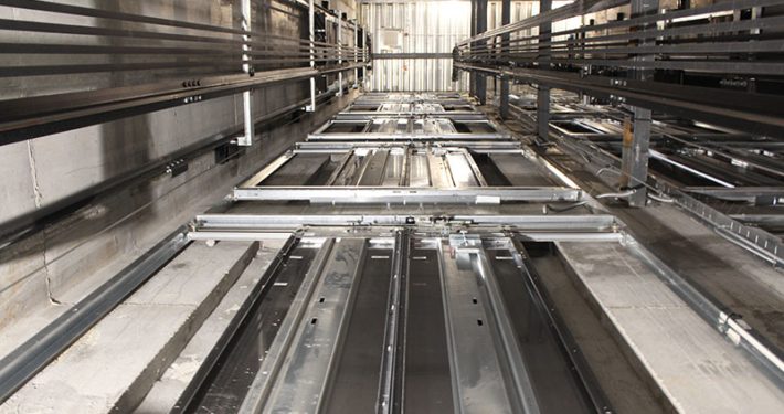 An elevator shaft containing elevator equipment installed by an elevator company. We help elevator company owners and manufacturers partner with skilled and highly-trained elevator technicians and mechanics who focus on the importance of safety, professionalism, and continuous education and training.