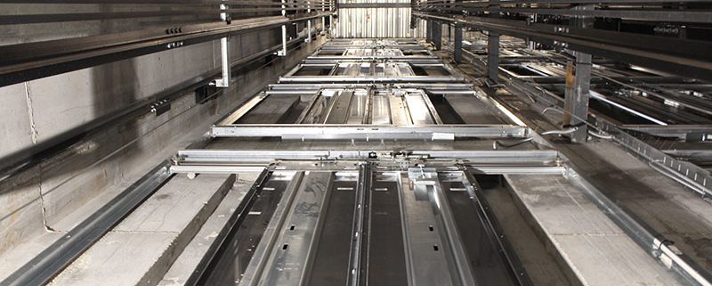 An elevator shaft containing elevator equipment installed by an elevator company. We help elevator company owners and manufacturers partner with skilled and highly-trained elevator technicians and mechanics who focus on the importance of safety, professionalism, and continuous education and training.